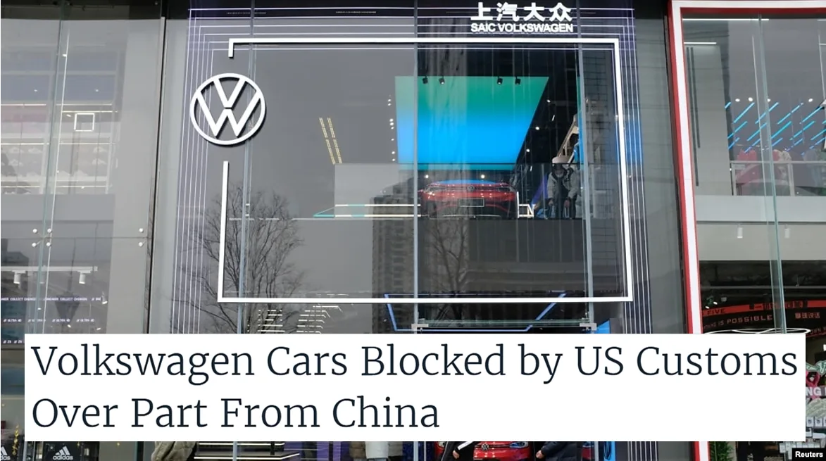 Volkswagen logo on a storefront with a headline stating US Customs blocks Volkswagen cars due to a part sourced from China.