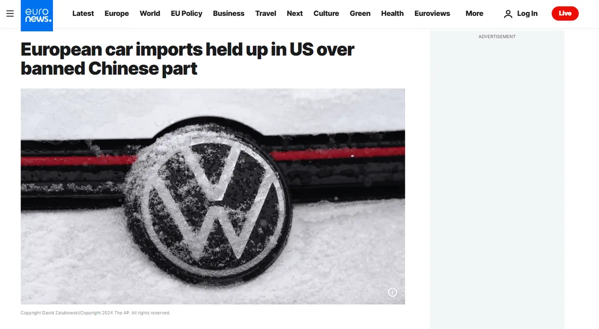 Close-up of snow-covered Volkswagen logo on a car with headline: European car imports held up in US over banned Chinese part